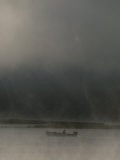 Buy On a Stormy Evening, a Lone Boater Floats Beneath an Ominous Sky at AllPosters.com