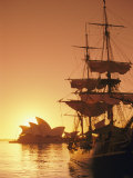 Sydney Opera House and the Hms Bounty, a Replica of the Famous Ship, Silhouetted by the Setting Sun