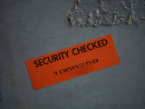 Buy A Security Sticker is Attached to a Piece of Baggage at AllPosters.com