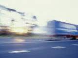 Buy A Tractor Trailer Speeding Down a Highway at Sunset at AllPosters.com