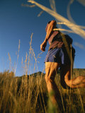 Buy A Man Runs Through Tall Grass Near Mt. Elden at AllPosters.com