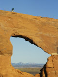 Buy Brad Richman Rides his Bicycle over Hole in the Rock Formation at AllPosters.com