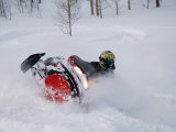 Buy A Snowmobiler Spins Through Deep Powder at AllPosters.com