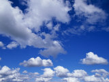Sunlit Fluffy White Clouds in a Blue Sky