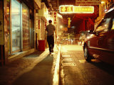 Man and a Taxi on a Shop-Lined Hong Kong Street at Night