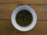 Tea Leaves Steep in a Cup of Hot Water for Green Tea