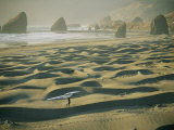 Buy A Windsurfer Walks Across the Sand Dunes Near the Rocky Coastline at AllPosters.com