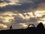 Buy A Mountain Biker Cycles Toward Tents at a Campsite at AllPosters.com