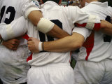 Rugby Players Huddle in a Scrum at the Annual Rugby Sevens