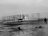 Orville Wright Taking Plane For 1st Motorized Flight as Brother Wilbur Wright Looks at Kitty Hawk