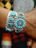 Close Up of Wrist Modeling Turquoise Bracelets Made by Native Americans