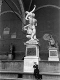 Man Sitting Beneath Statue of Giambologna's 