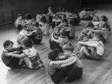 First Graders Playing Rowboat on the Floor in Their Physical Education Class