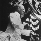 Woodrow Wilson, 28th President of the U.S, Speaking from Podium under Flag Bunting