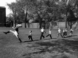 Buy Uniformed Drum Major For University of Michigan Marching Band Practicing His High Kicking Prance at AllPosters.com