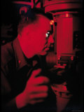 Comm. James Calvert Looking Through Periscope in Control Center Aboard Nuclear Submarine USS Skate