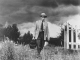 Country Doctor Ernest Ceriani Making House Call on Foot in Small Town