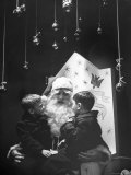 Department Store Santa Clause with Talking with Two Boys Sitting on His Lap