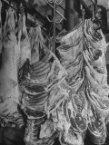 Big Pieces of Meat Hanging in the Wholesaler's Shop