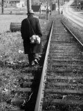 Buy Elderly Hobo, with Bundle Strapped to His Back, Walking Along Train Tracks at AllPosters.com