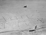 Buy Girl Standing by the Words "Vote Labour" Written in the Sand at AllPosters.com