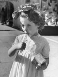 British Child Sucking on a Piece of Candy