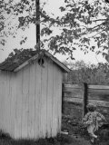 Small Child Running to the Outhouse at Rural School