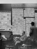 Large Board Containing Small Hand Written Pieces of Paper Announcing Various Jobs and the Salaries