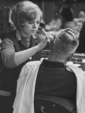Female Barber Cutting a Customer's Hair in a Barber Shop