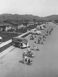 Diaper Service Trucks and Mothers with Babies They Service Line Street
