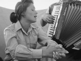 Young Israeli Woman Singing While Accompanied by Someone Playing an Accordion