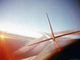 Vapor Trails Streaming from Tail of Jet in Flight