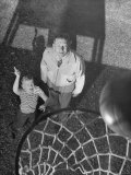 Oklahoma A&M Basketball Coach Hank Iba Watching a Young Boy Shooting a Basket