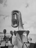 Tuba Player Keeping His Head Dry in a Rainstorm During Visit to St. Croix by Pres. Harry S. Truman