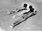 Three Native Boys Sunbathing Nude at the Edge of the Surf at Ocean Beach