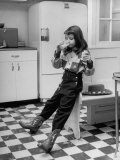 Young Girl Wearing Cowgirl Outfit Drinking Milk and Eating Sandwich in Kitchen