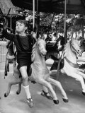 Buy Young Turkish Prodigy Hassan Kaptan Riding a Merry Go Round at AllPosters.com