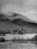 Buy Old Scottish Castle Standing on a River Peninsula, with Mountain Rising in Background at AllPosters.com