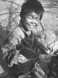 Smiling Waif Happily Hugging a Gallon Tin Can