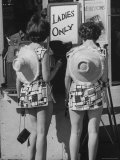 Women Outside Movie Theater Reading Signs