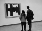 People Looking at a Painting by Robert Motherwell at an American Art Show