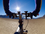 Buy A Man Cycling Across a Desert Landscape at AllPosters.com