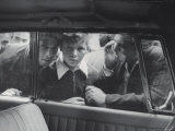 People Looking in Car Window