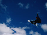 Buy A Snowboarder Launches in the Air and Appears for a Second to Be Riding the Clouds at AllPosters.com