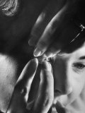 Woman Cautiously Placing a Contact Lens in Her Eye