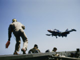 A Fighter Plane Lands Onboard an Aircraft Carrier