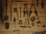 An Assortment of Hand Tools Hang on a Plank Wall