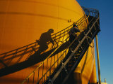 A Workman Climbs a Stairway on a Petroleum Storage Tank