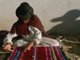 A Bolivian Woman Weaves Brightly Colored Fabric on a Loom