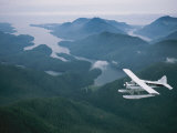 Buy A Beaver Airplane on Floats Flies over Islands and Snowy Mountains at AllPosters.com